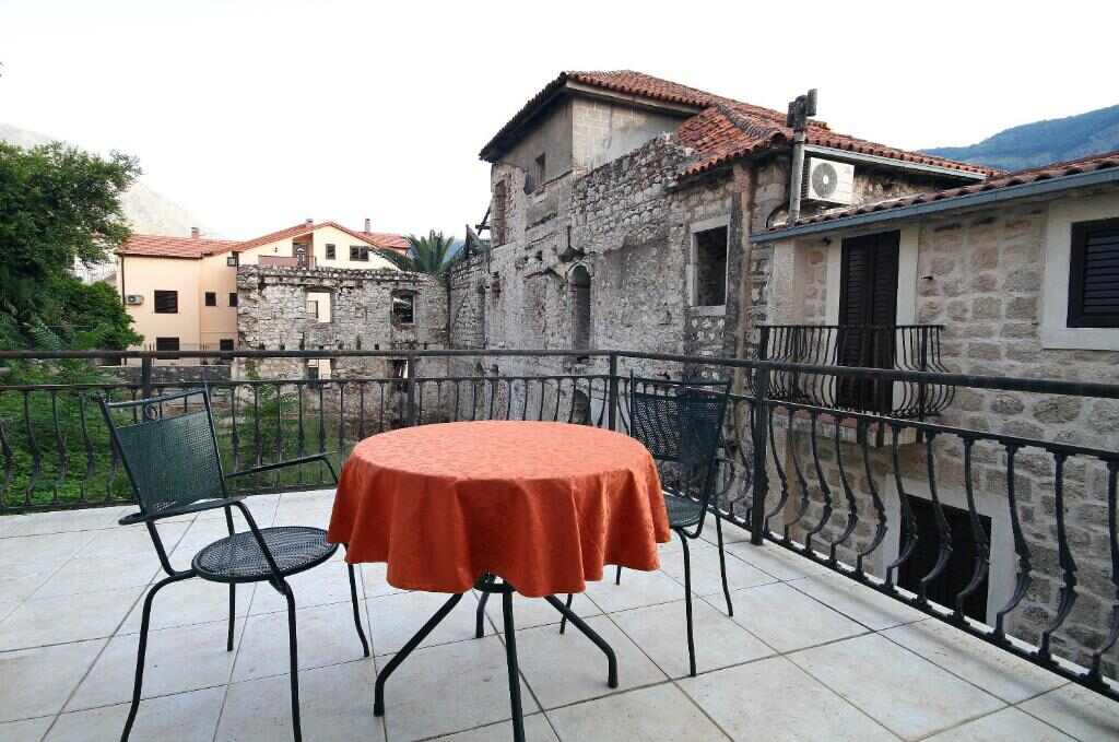 Terrace with table and chairs at Vila Panonija in Dobrota, Kotor